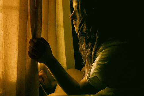 Girl looking out of window