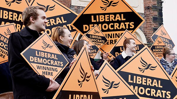 A big group of Lib Dems with Posters