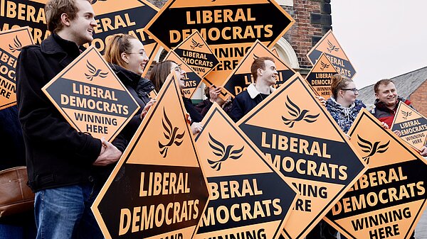 A group of Lib Dems with posters